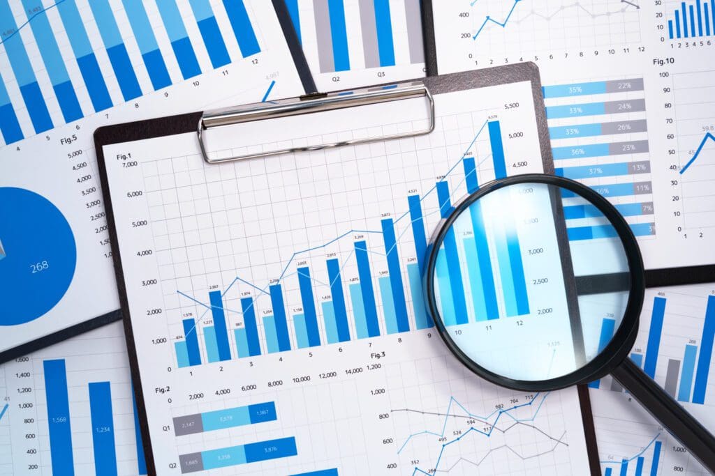 Growth charts, business reports, and magnifying glass